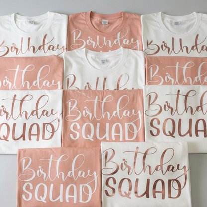 Pink and white personalized Birthday Squad vinyl T-shirts arranged together