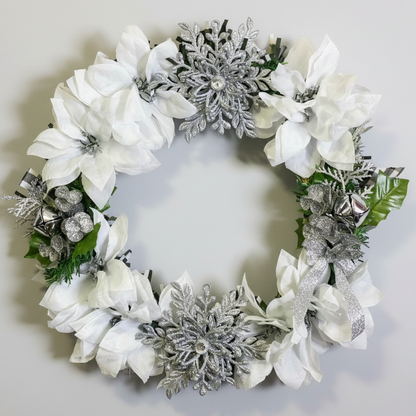 Handcrafted white and silver Christmas wreath with poinsettias and snowflake ornaments
