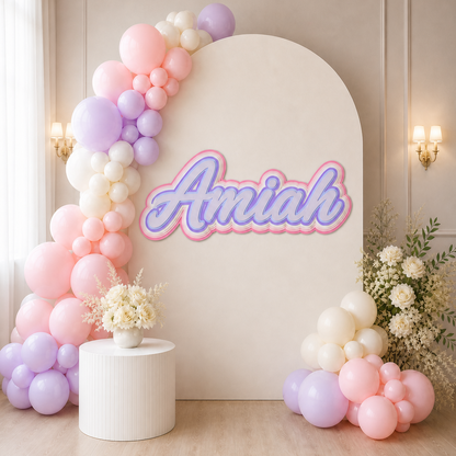 Custom 3D layered cardstock name sign reading Amiah displayed on a pastel balloon party backdrop